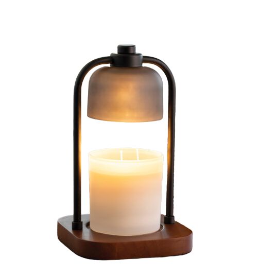 A floating candle lamp with a frosted glass shade hovering above a lit white candle in a wooden base, set against a plain white background.